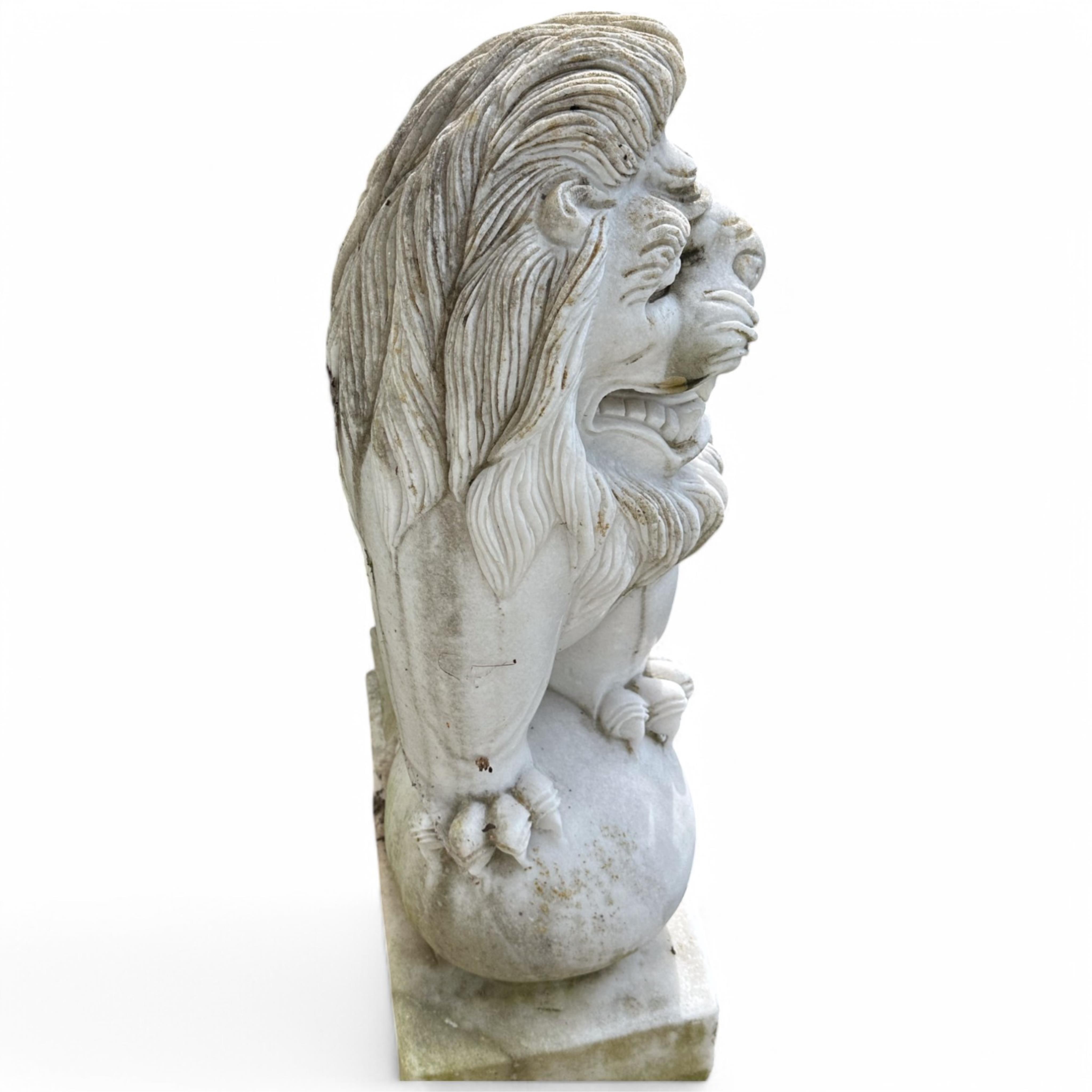 A pair of reconstituted white marble models of lions rampant